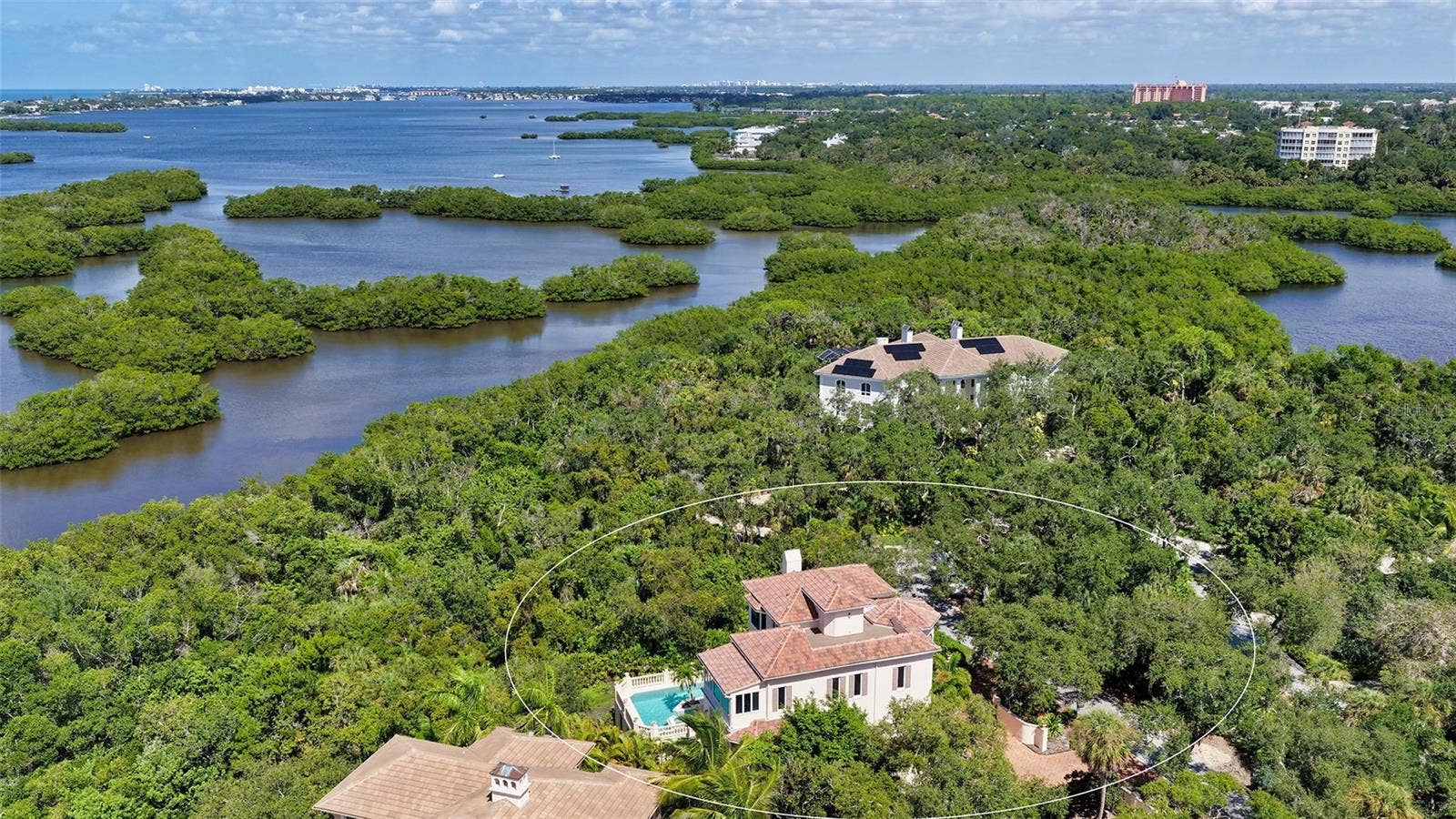 168 COASTAL HAMMOCK COURT, Osprey, FL 34229 The residence is embraced by mature vegetation and the waterways surrounding Little Sarasota Bay.