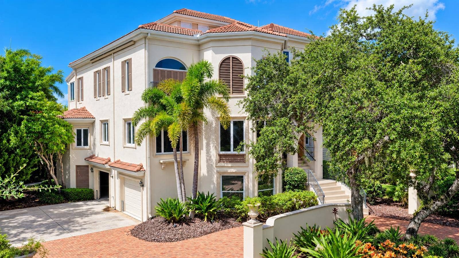 168 COASTAL HAMMOCK COURT, Osprey, FL 34229 Graceful arched windows, a tile roof and distinctive architectural details give the residence its signature Mizner inspired style.
