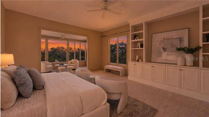 168 COASTAL HAMMOCK COURT, Osprey, FL 34229 Expansive windows bring dramatic sunset colors directly into the private primary retreat.