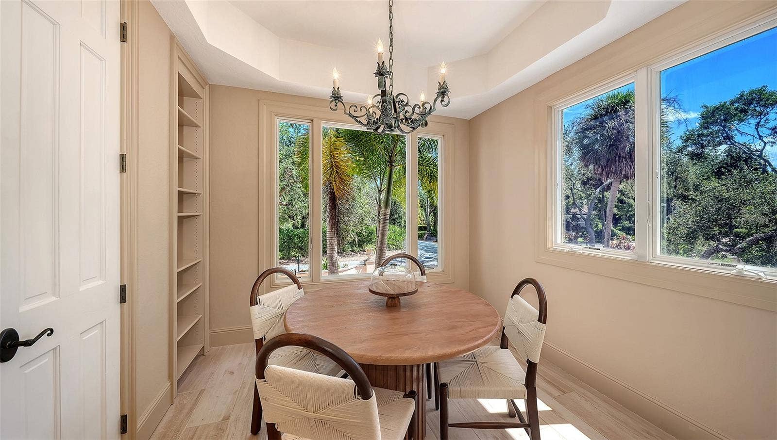 168 COASTAL HAMMOCK COURT, Osprey, FL 34229 Surrounded by windows and greenery, this intimate dining nook offers a peaceful setting for casual meals.