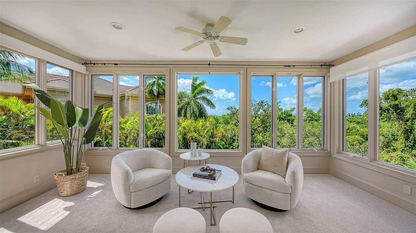 168 COASTAL HAMMOCK COURT, Osprey, FL 34229 A light filled sitting area within the primary suite provides a serene place to relax while enjoying views of the tropical surroundings.