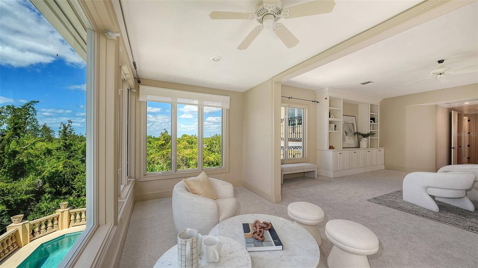 168 COASTAL HAMMOCK COURT, Osprey, FL 34229 Large windows capture treetop and pool views while filling the primary retreat with beautiful natural light.