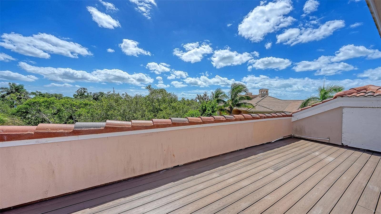 168 COASTAL HAMMOCK COURT, Osprey, FL 34229 An expansive rooftop terrace creates a remarkable outdoor vantage point above the surrounding treetops.