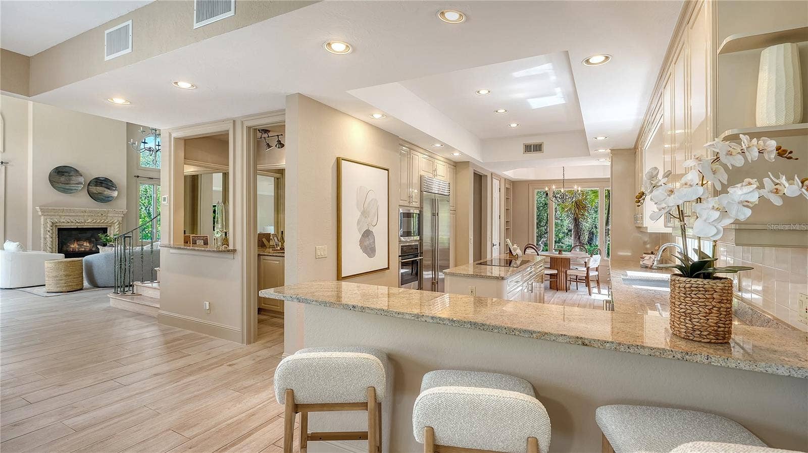 168 COASTAL HAMMOCK COURT, Osprey, FL 34229 An expansive counter provides abundant workspace and casual seating while connecting the kitchen to the heart of the home.