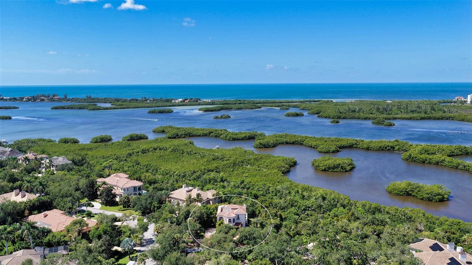 168 COASTAL HAMMOCK COURT, Osprey, FL 34229 Sweeping aerial views showcase the extraordinary natural setting along Little Sarasota Bay and the surrounding coastal landscape.
