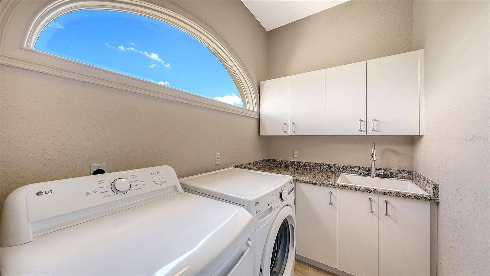 168 COASTAL HAMMOCK COURT, Osprey, FL 34229 A private laundry area with cabinetry and workspace adds convenience to the primary suite level.