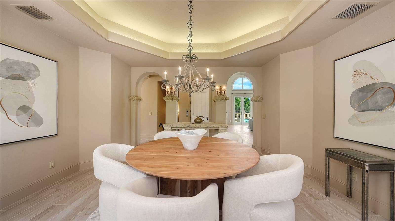 168 COASTAL HAMMOCK COURT, Osprey, FL 34229 The dining room's graceful proportions and architectural detailing create an inviting space for memorable gatherings.