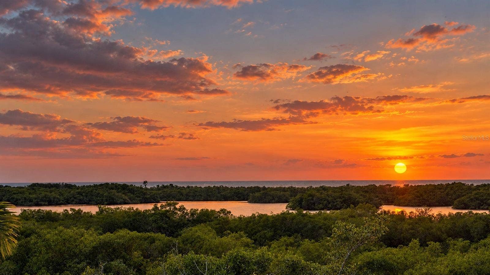 168 COASTAL HAMMOCK COURT, Osprey, FL 34229 Panoramic rooftop views provide a spectacular vantage point for sunsets over Little Sarasota Bay.