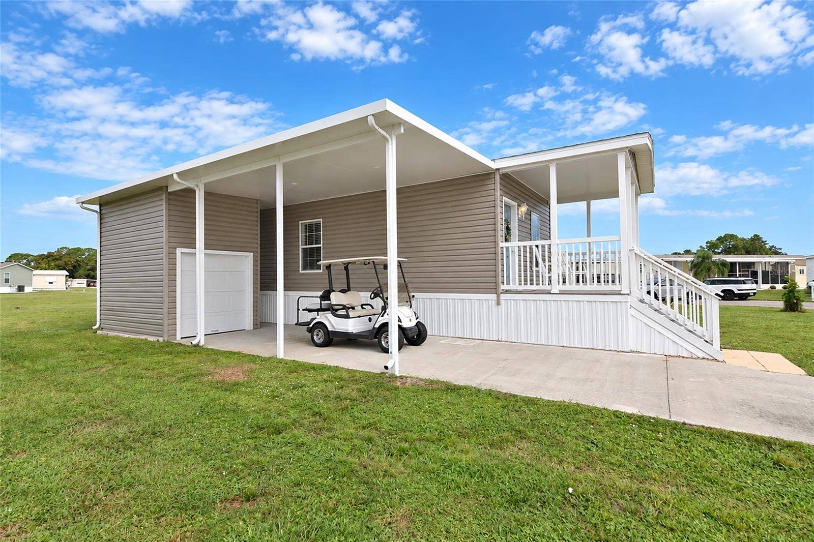 6843 HIKINA DRIVE, North Port, FL 34287 Shed with space to park your golf cart. Covered Car Port with plenty of parking space.