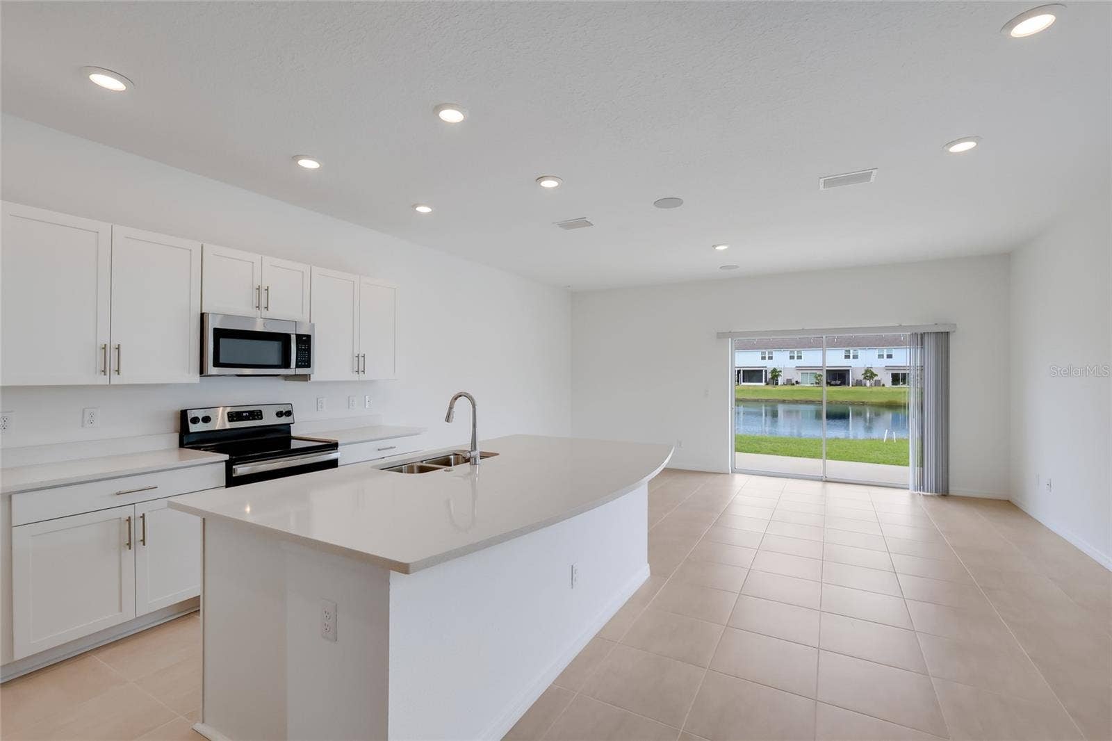 15150 GINETTI STREET, Nokomis, FL 34275 The gorgeous white cabinets and white quartz countertops make the inside bright and airy. The lake views from the kitchen and the family room are second-to-none!