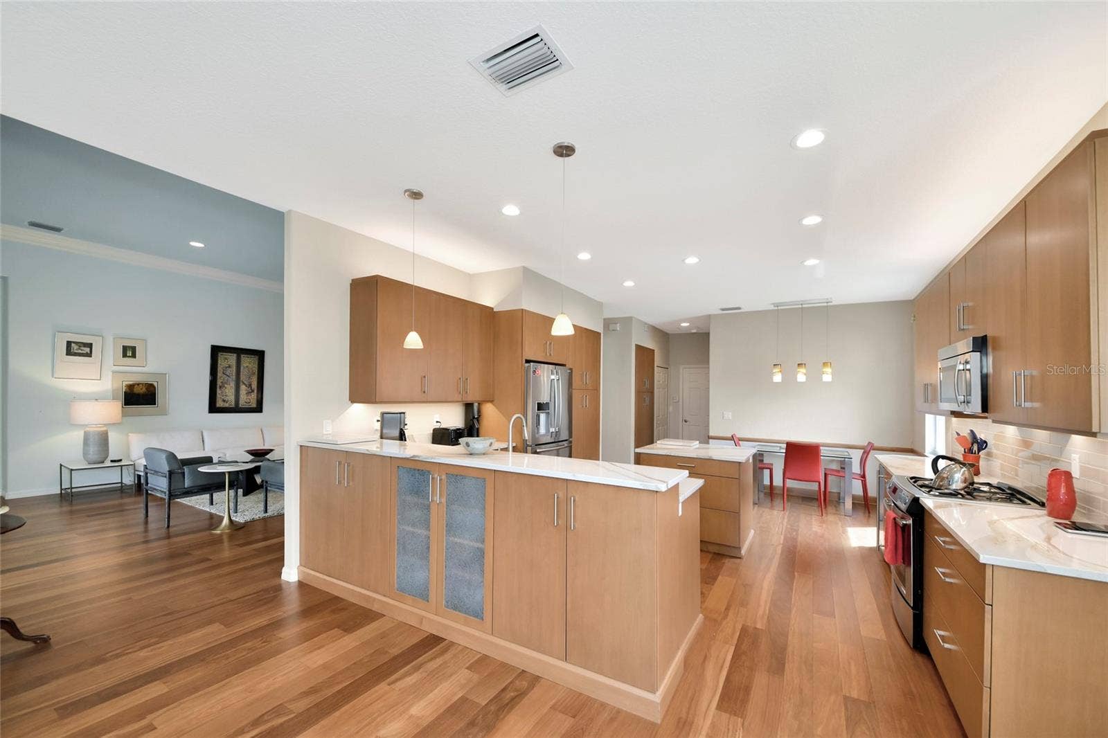 6256 DONNINGTON COURT, Sarasota, FL 34238 Pass through bar w/ pendant lights and extra storage cabinets.