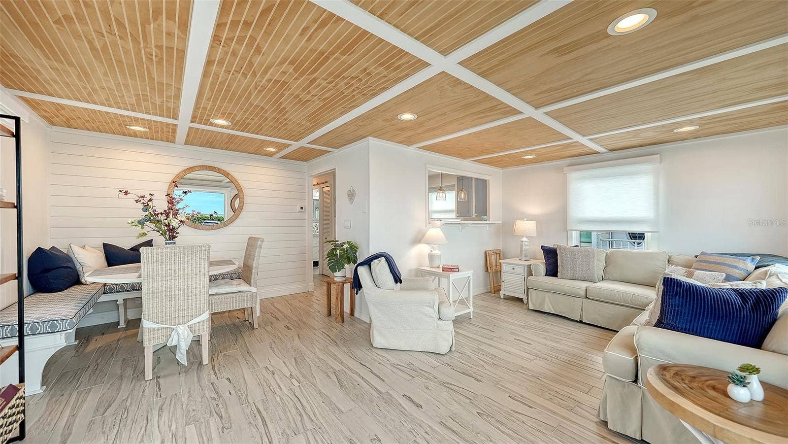 Dining area and living room with kitchen behind the opening/wall