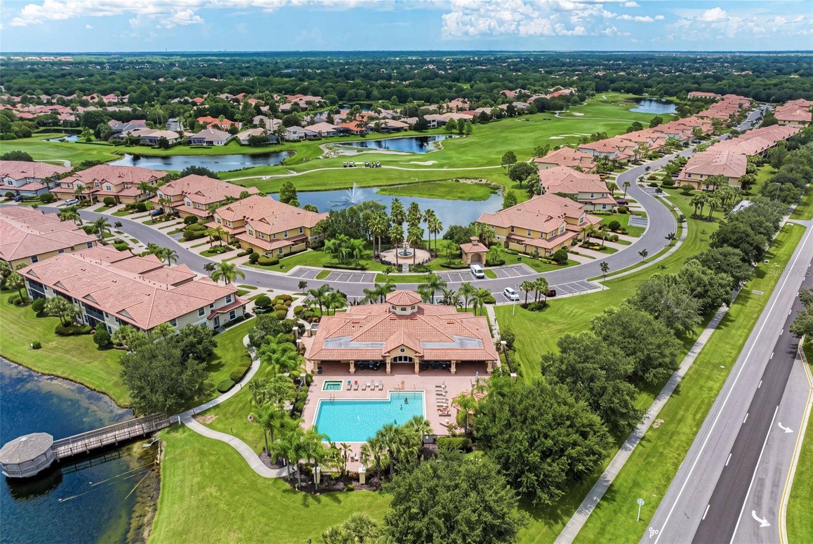 8432 MIRAMAR WAY, Lakewood Ranch, FL 34202 A beautiful aerial look at Miramars lakes, golf course surroundings, and community pool.