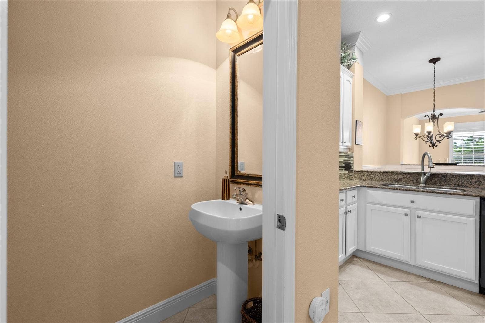 8432 MIRAMAR WAY, Lakewood Ranch, FL 34202 A conveniently located half bath just off the kitchen makes hosting guests easy.