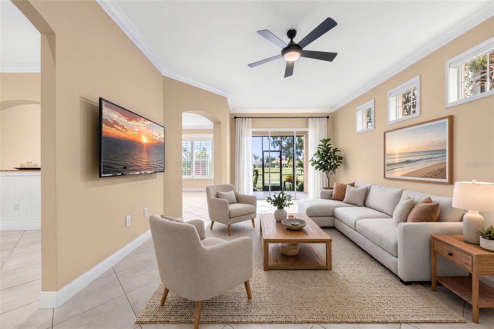 8432 MIRAMAR WAY, Lakewood Ranch, FL 34202 High ceilings and natural light create an inviting space to relax, with golf course views just beyond the sliders.