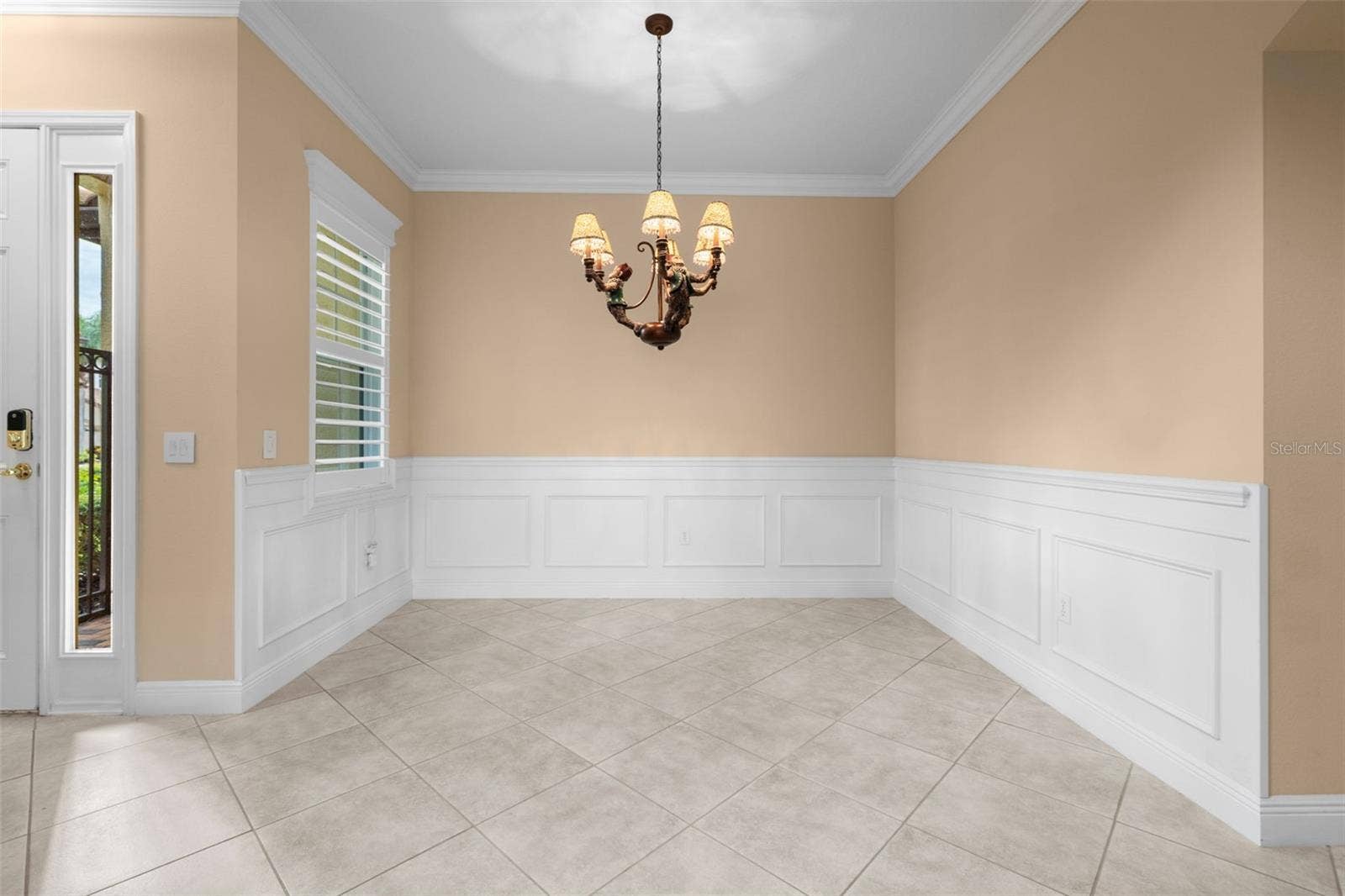 8432 MIRAMAR WAY, Lakewood Ranch, FL 34202 Classic wainscoting and crown molding create a lovely setting for dinners with family and friends.