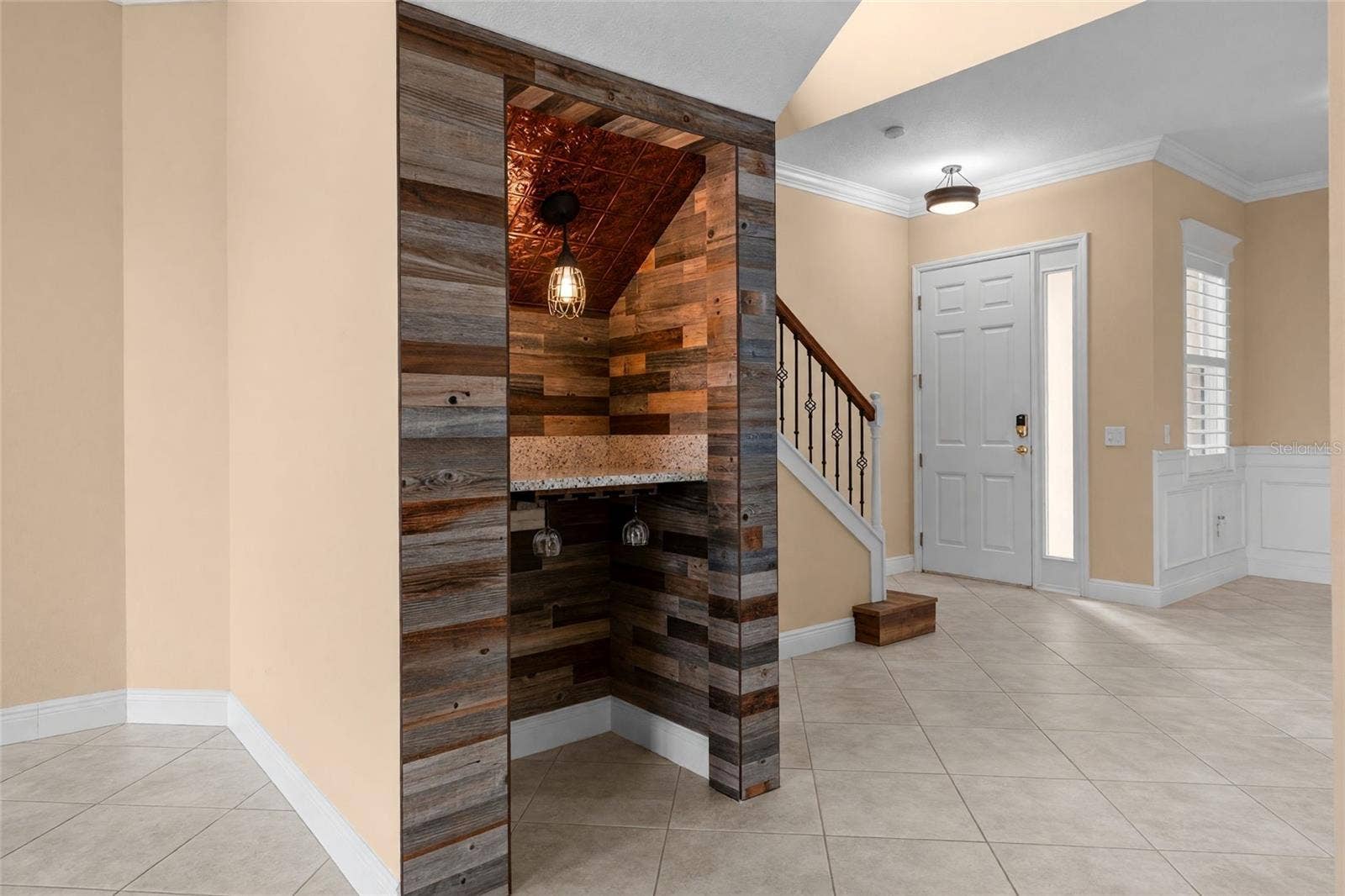 8432 MIRAMAR WAY, Lakewood Ranch, FL 34202 Wood accents, a decorative ceiling, and pendant lighting make this custom wine nook a conversation piece.