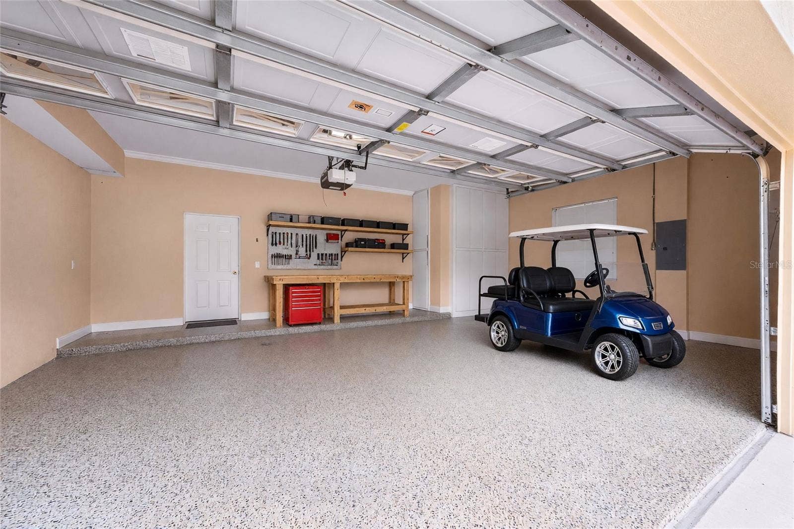 8432 MIRAMAR WAY, Lakewood Ranch, FL 34202 Extra built in custom storage and an epoxy-finished floor make this garage a standout feature.