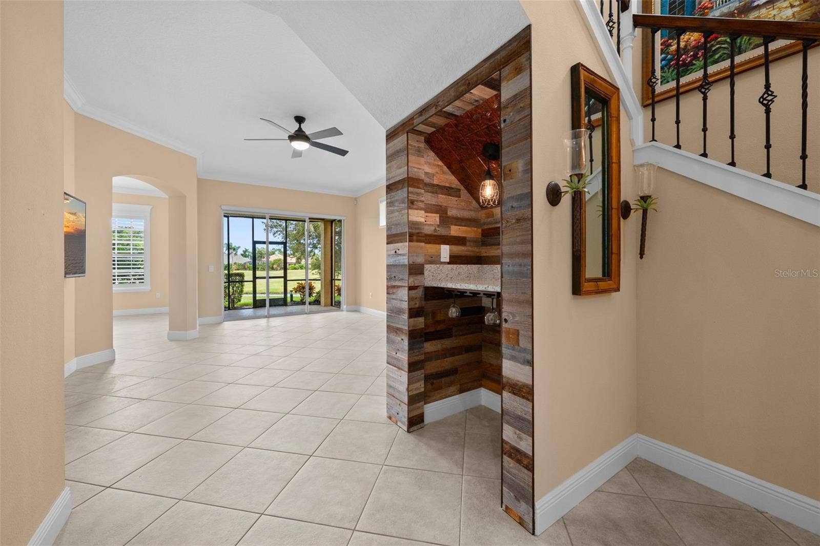 8432 MIRAMAR WAY, Lakewood Ranch, FL 34202 An open layout draws you toward the lanai, with a custom wine nook adding character along the way.