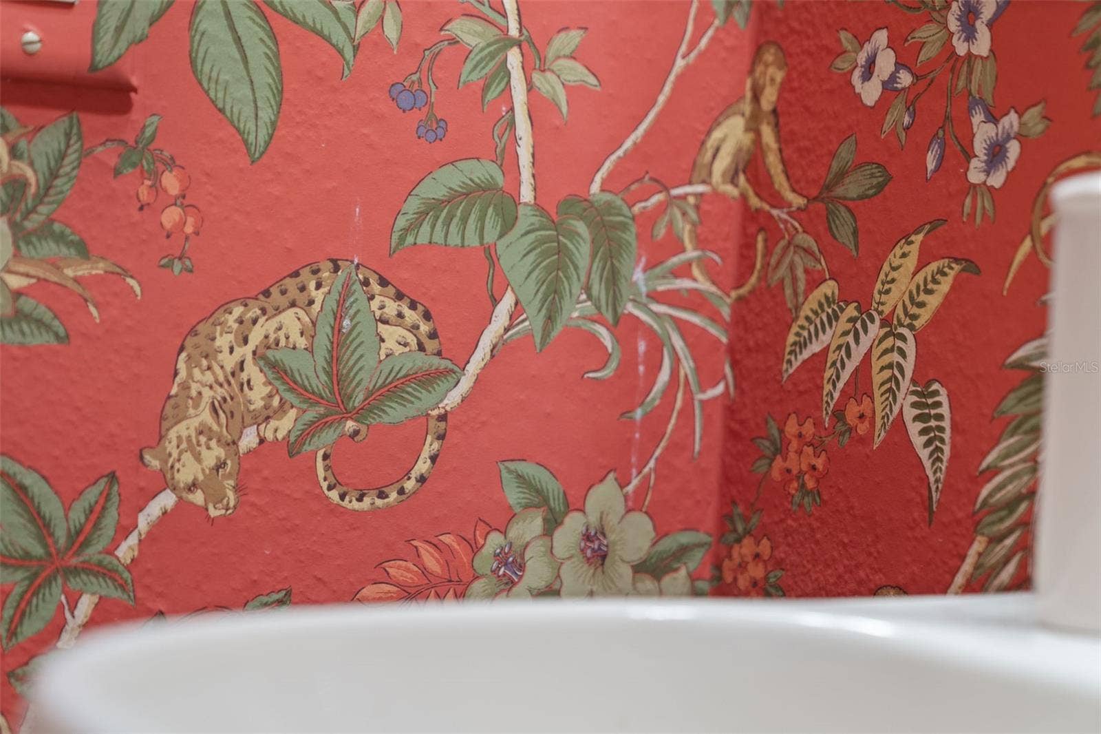 8432 MIRAMAR WAY, Lakewood Ranch, FL 34202 Cheerful patterned wallpaper and a classic pedestal sink bring personality to this bathroom.