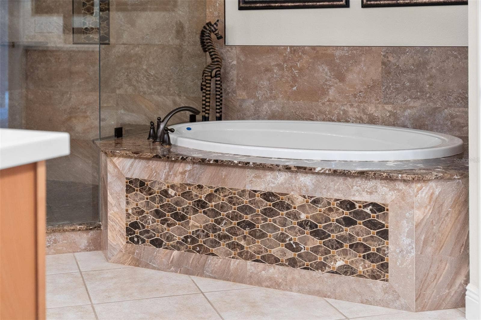 8432 MIRAMAR WAY, Lakewood Ranch, FL 34202 Unwind in the soaking tub, surrounded by rich stone finishes and decorative accents.
