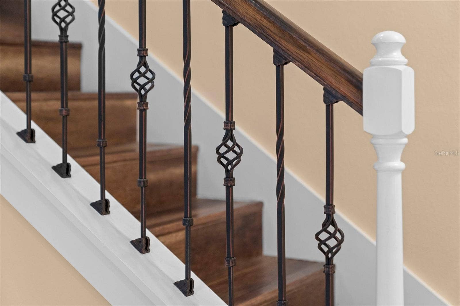 8432 MIRAMAR WAY, Lakewood Ranch, FL 34202 Rich wood tones and decorative ironwork add character to the staircase.