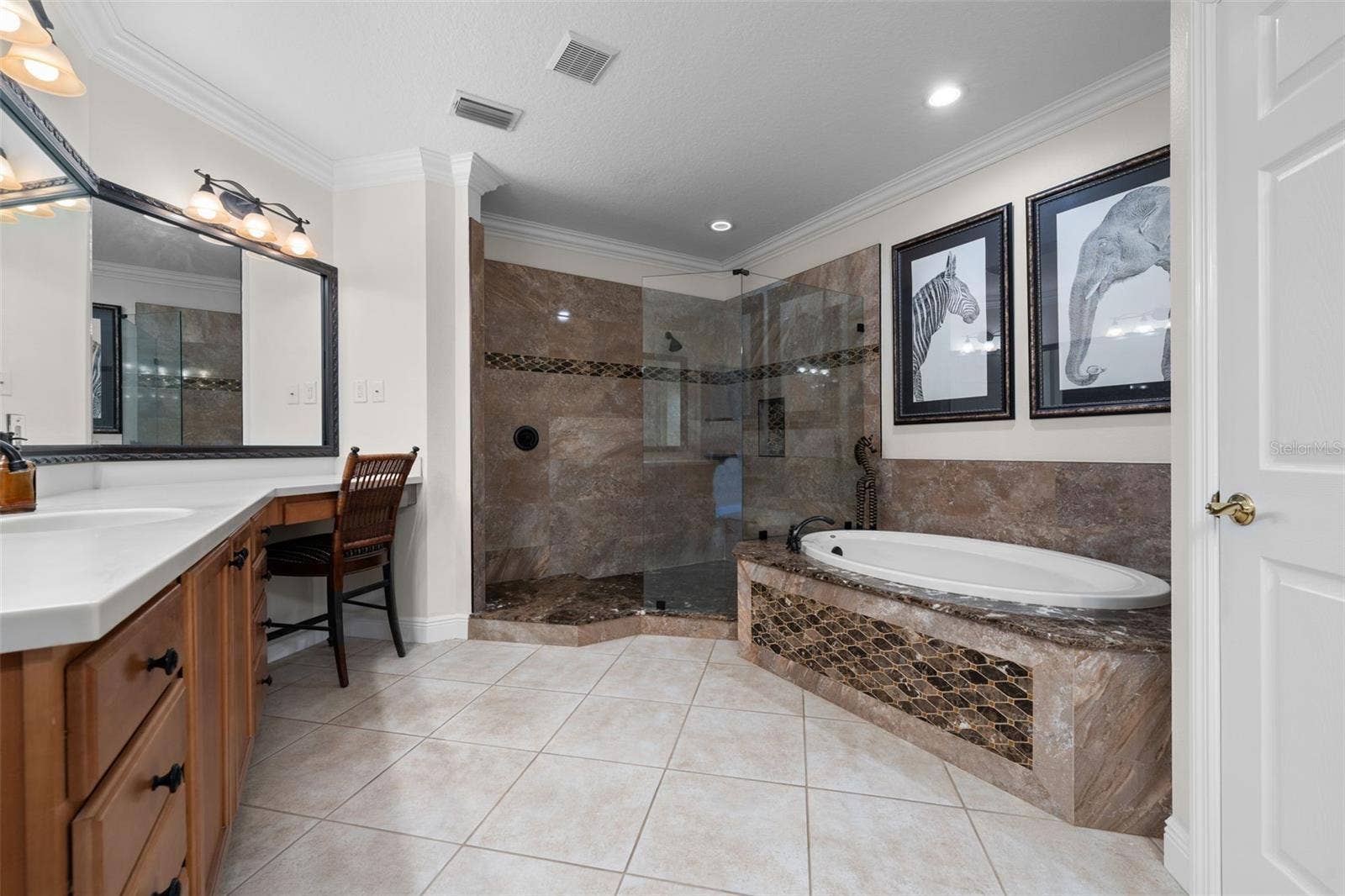 8432 MIRAMAR WAY, Lakewood Ranch, FL 34202 A spacious retreat with a soaking tub, glass-enclosed shower, and plenty of room to get ready.