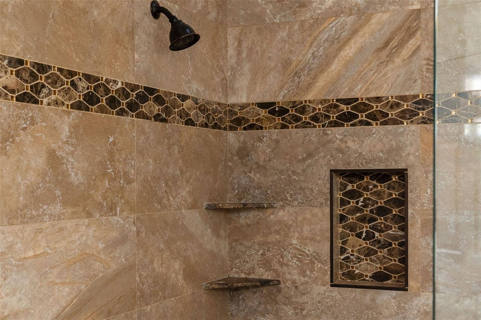 8432 MIRAMAR WAY, Lakewood Ranch, FL 34202 A generous shower with mosaic detailing, built-in shelves, and a recessed niche for everyday essentials.