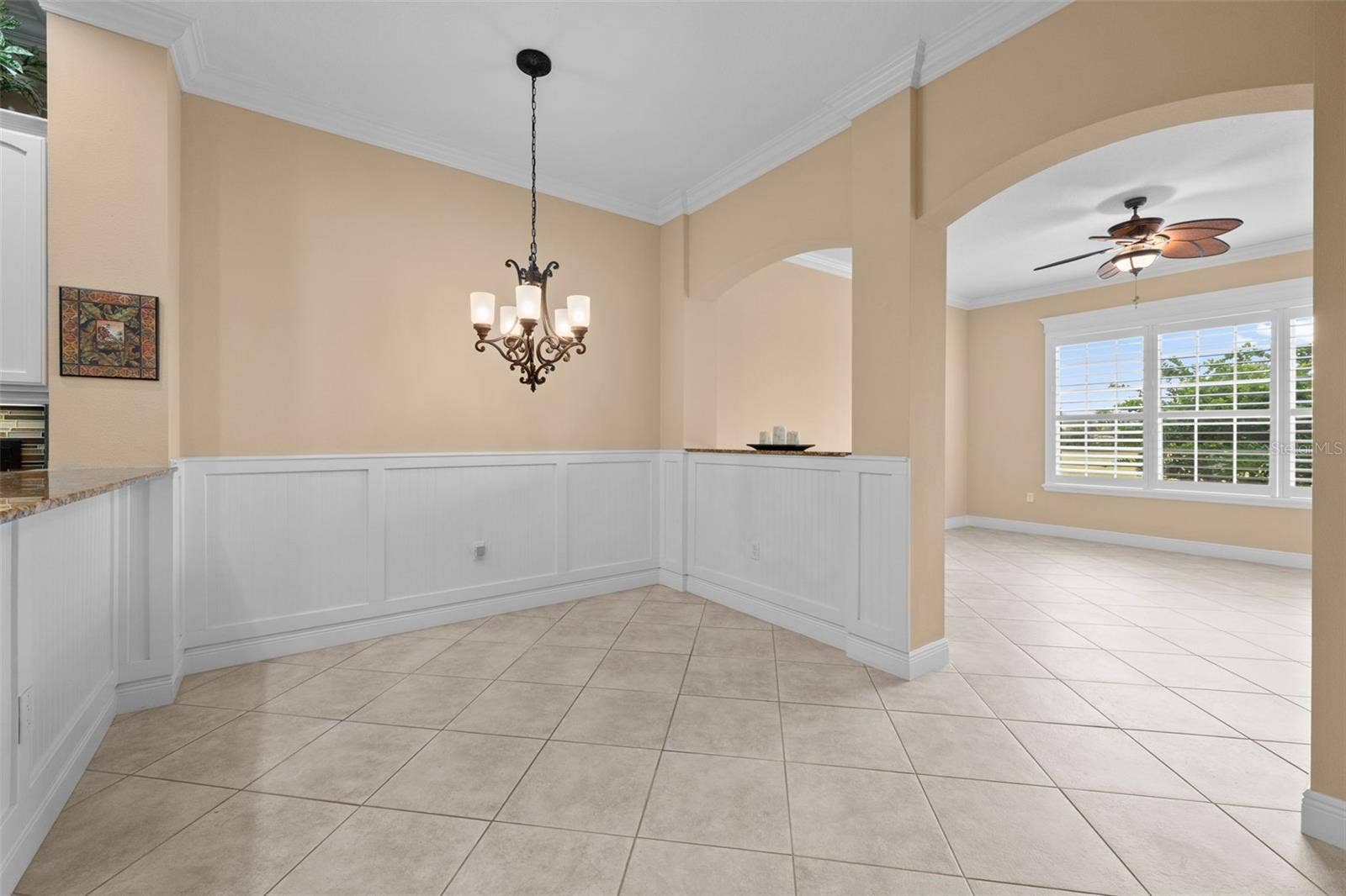 8432 MIRAMAR WAY, Lakewood Ranch, FL 34202 A charming spot for casual meals, framed by classic wainscoting and arched openings.