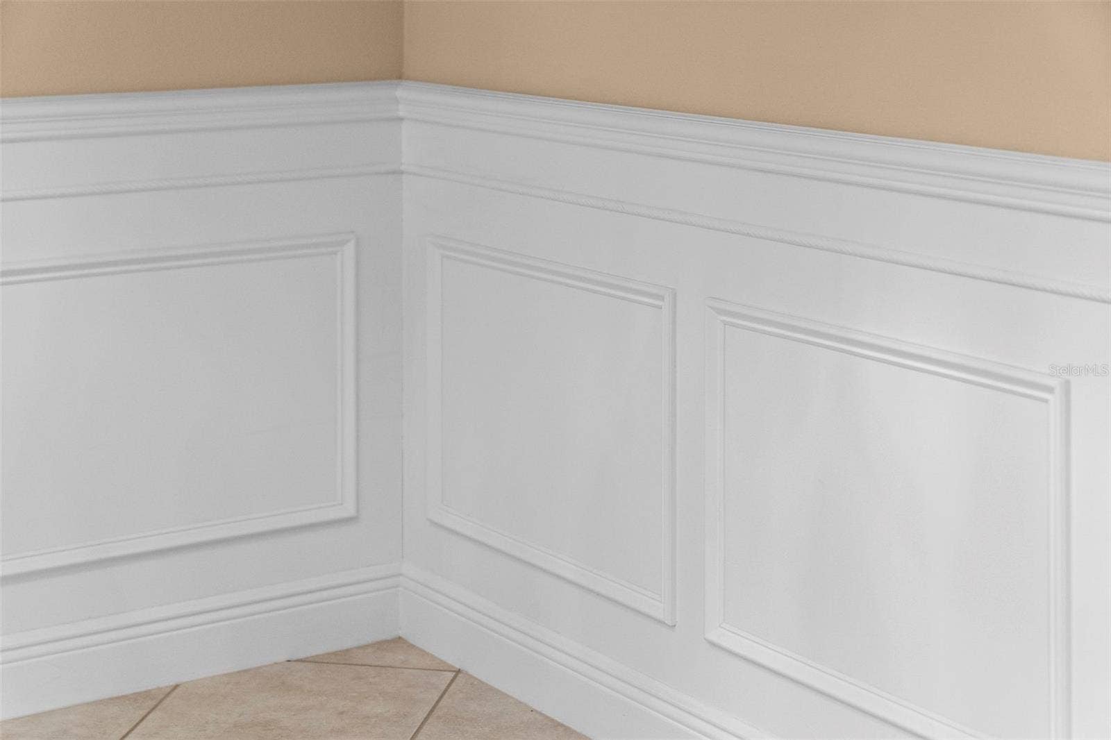 8432 MIRAMAR WAY, Lakewood Ranch, FL 34202 Detailed wainscoting adds timeless charm to the homes gathering spaces.