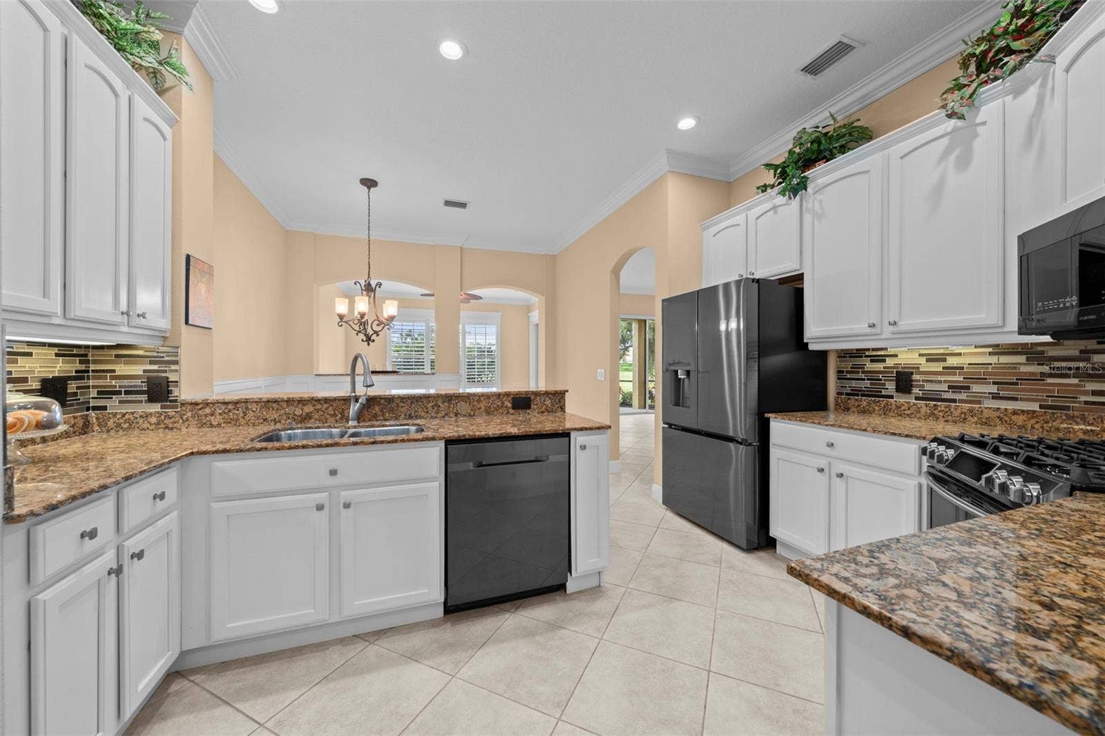 8432 MIRAMAR WAY, Lakewood Ranch, FL 34202 An open kitchen layout offers ample prep space while keeping you connected to family and guests.