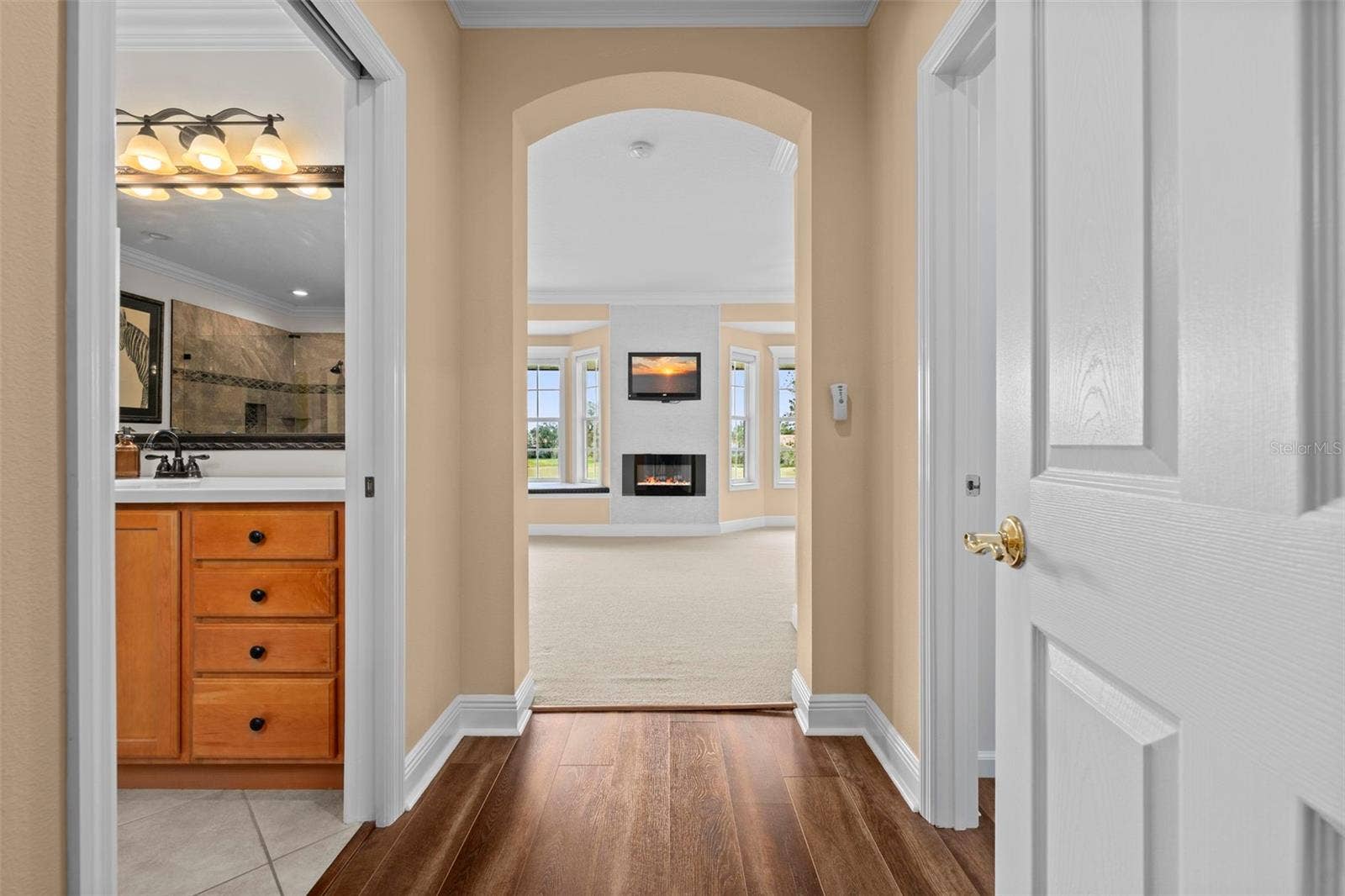 8432 MIRAMAR WAY, Lakewood Ranch, FL 34202 An arched entry leads into the primary retreat, with the ensuite bath close at hand.