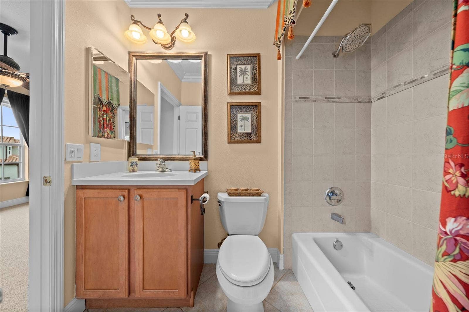 8432 MIRAMAR WAY, Lakewood Ranch, FL 34202 A conveniently arranged guest bath with a tub-and-shower combination and vanity storage.