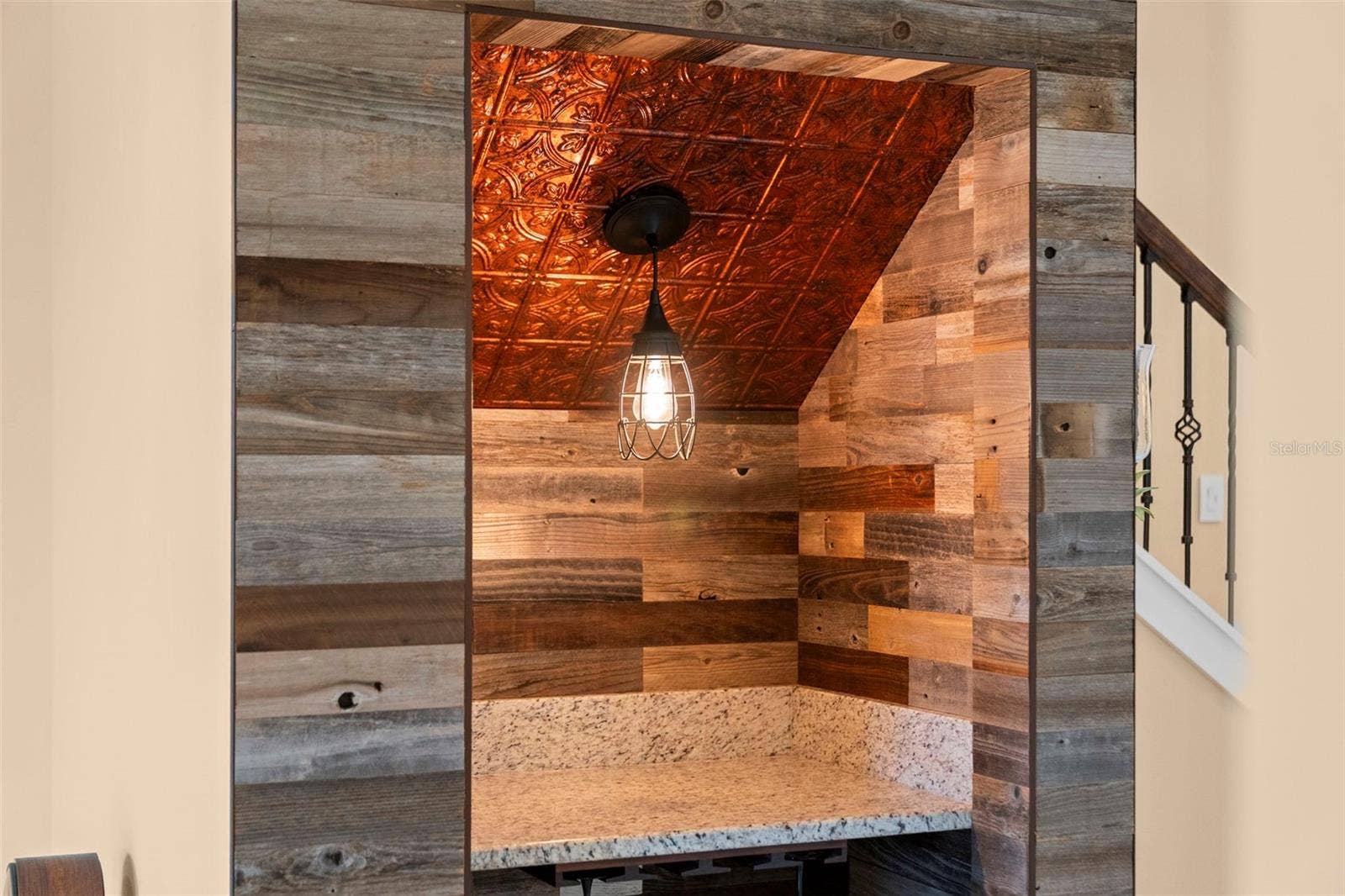 8432 MIRAMAR WAY, Lakewood Ranch, FL 34202 Wood accents, a decorative ceiling, and pendant lighting make this custom wine nook a conversation piece.