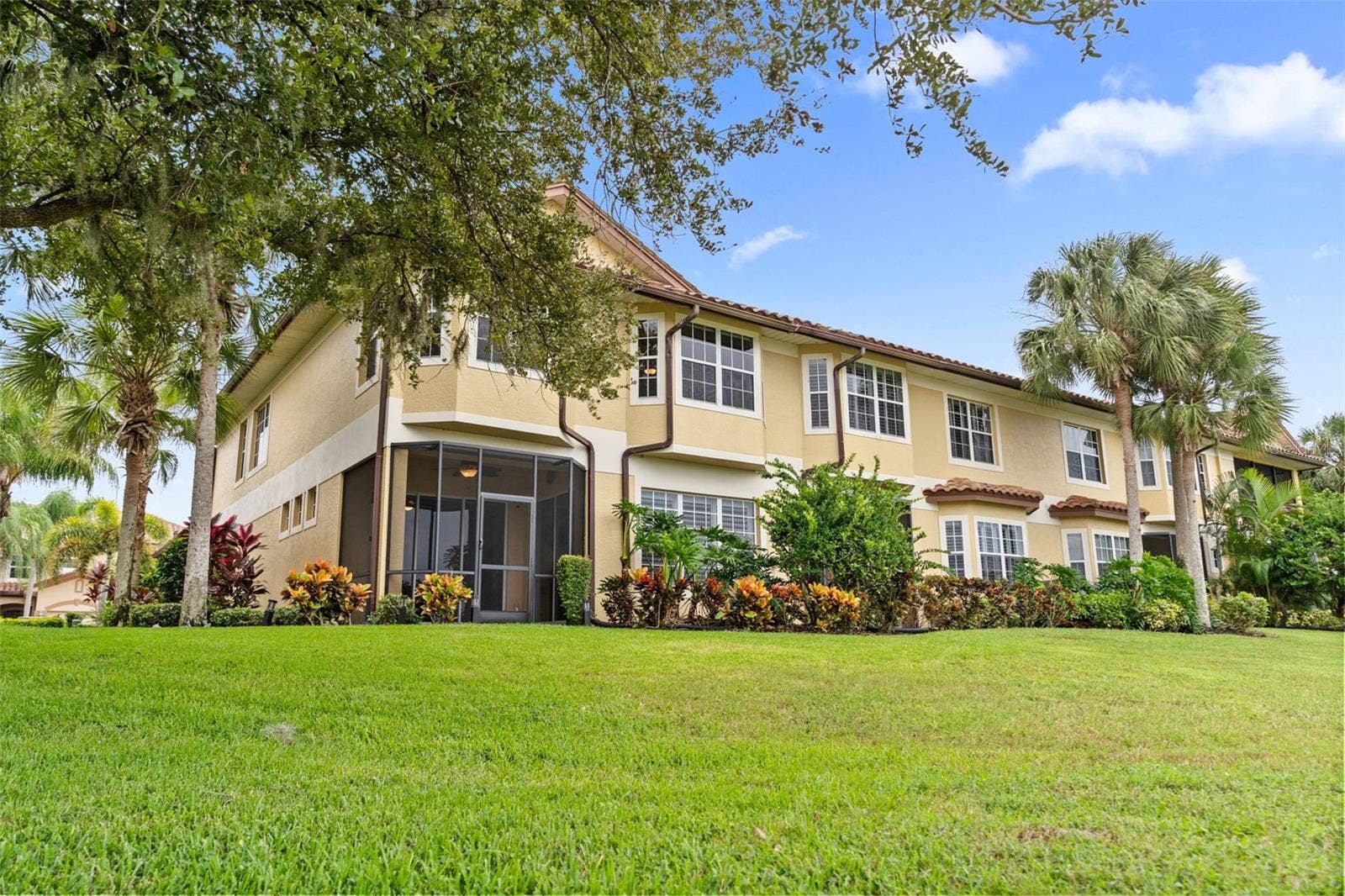 8432 MIRAMAR WAY, Lakewood Ranch, FL 34202 Tropical landscaping and a screened lanai create an inviting setting to enjoy the outdoors.