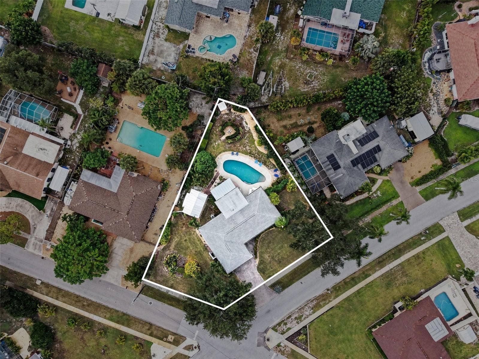 1/3 ACRE CORNER SITE WITH SIDE PARKING FOR RV OR BOAT.  LARGE WORKSHOP AND REAR SHED.  MATURE OAK AND THE SWEETEST MANGO TREE, JASMINE AND PRIVACY FENCE