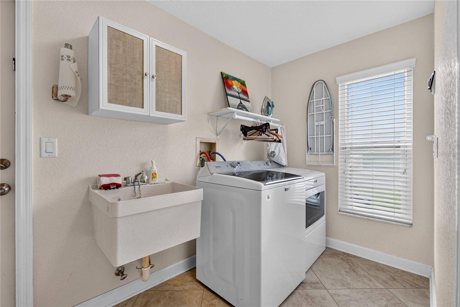 LAUNDRY ROOM BETWEEN KITCHEN AND GARAGE.