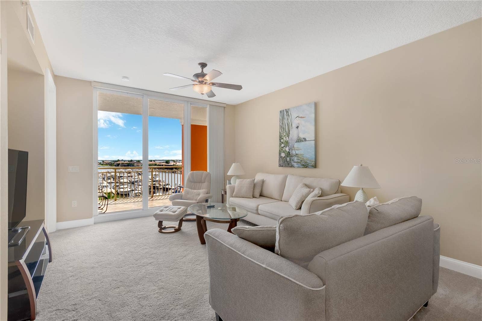 606 RIVIERA DUNES WAY, #405, Palmetto, FL 34221 Living Room features Sliding Glass Doors to Lanai overlooking the Riviera Dunes Marina