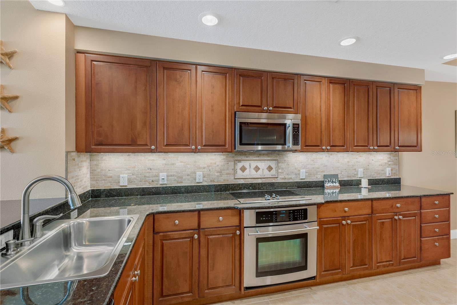 606 RIVIERA DUNES WAY, #405, Palmetto, FL 34221 Spacious Kitchen with Roll-out shelving in all lower cabinets and under cabinet lighting.