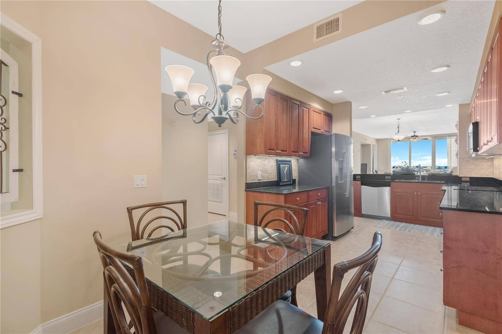 606 RIVIERA DUNES WAY, #405, Palmetto, FL 34221 Eat-in Kitchen area. Stainless steel appliances and new (2025) counter depth Refrigerator.