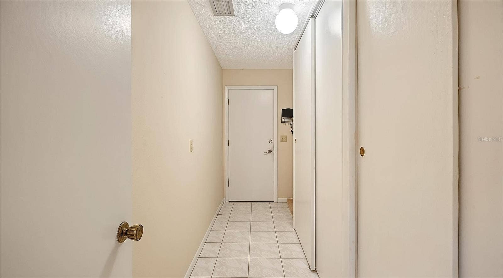 The hall from the kitchen to the garage has plenty of extra closet space.