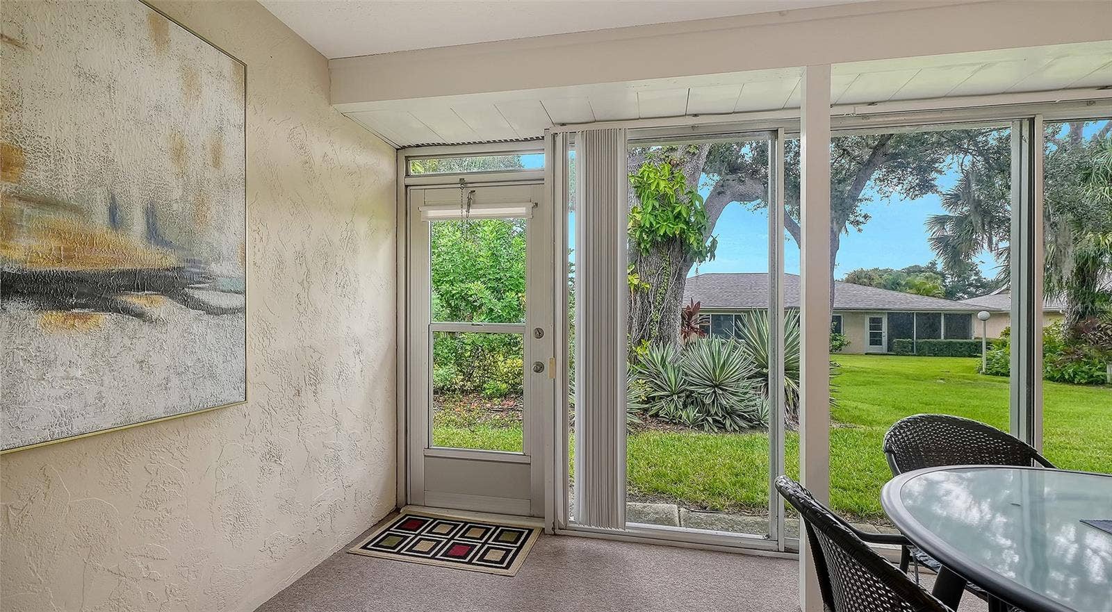 The lanai has its own door to the luscious greenbelt.