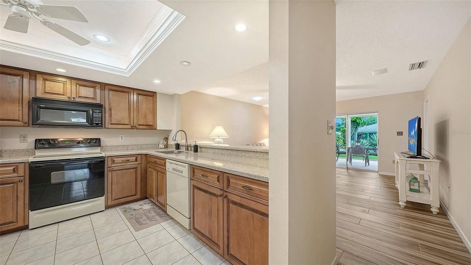 Wood cabinets with granite counters in the kitchen.