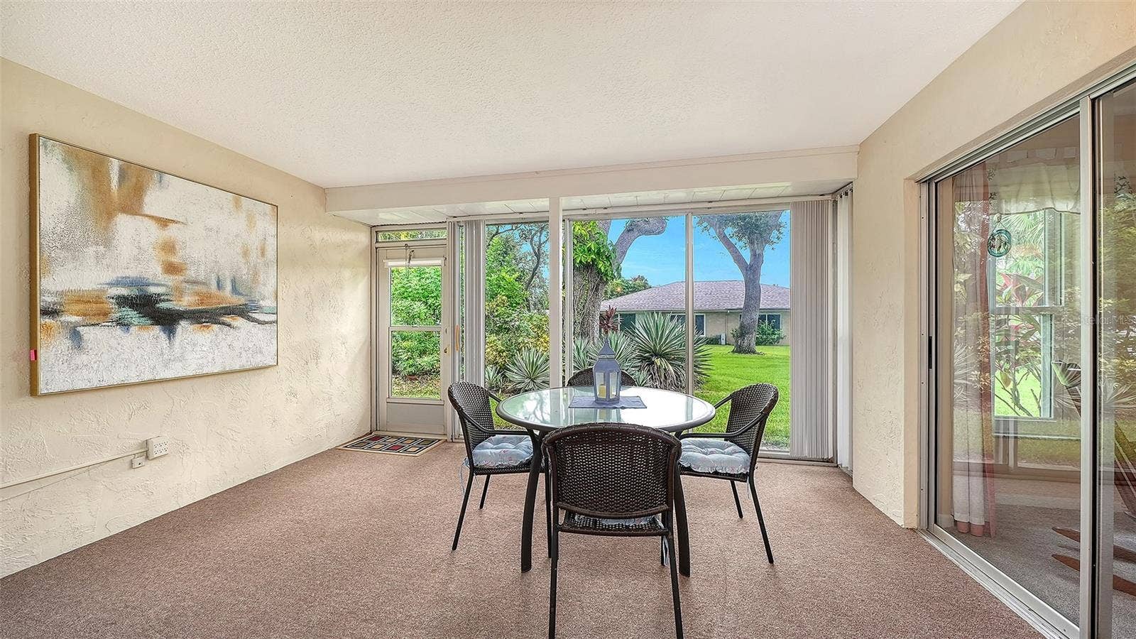 A large lanai with glass and screens.