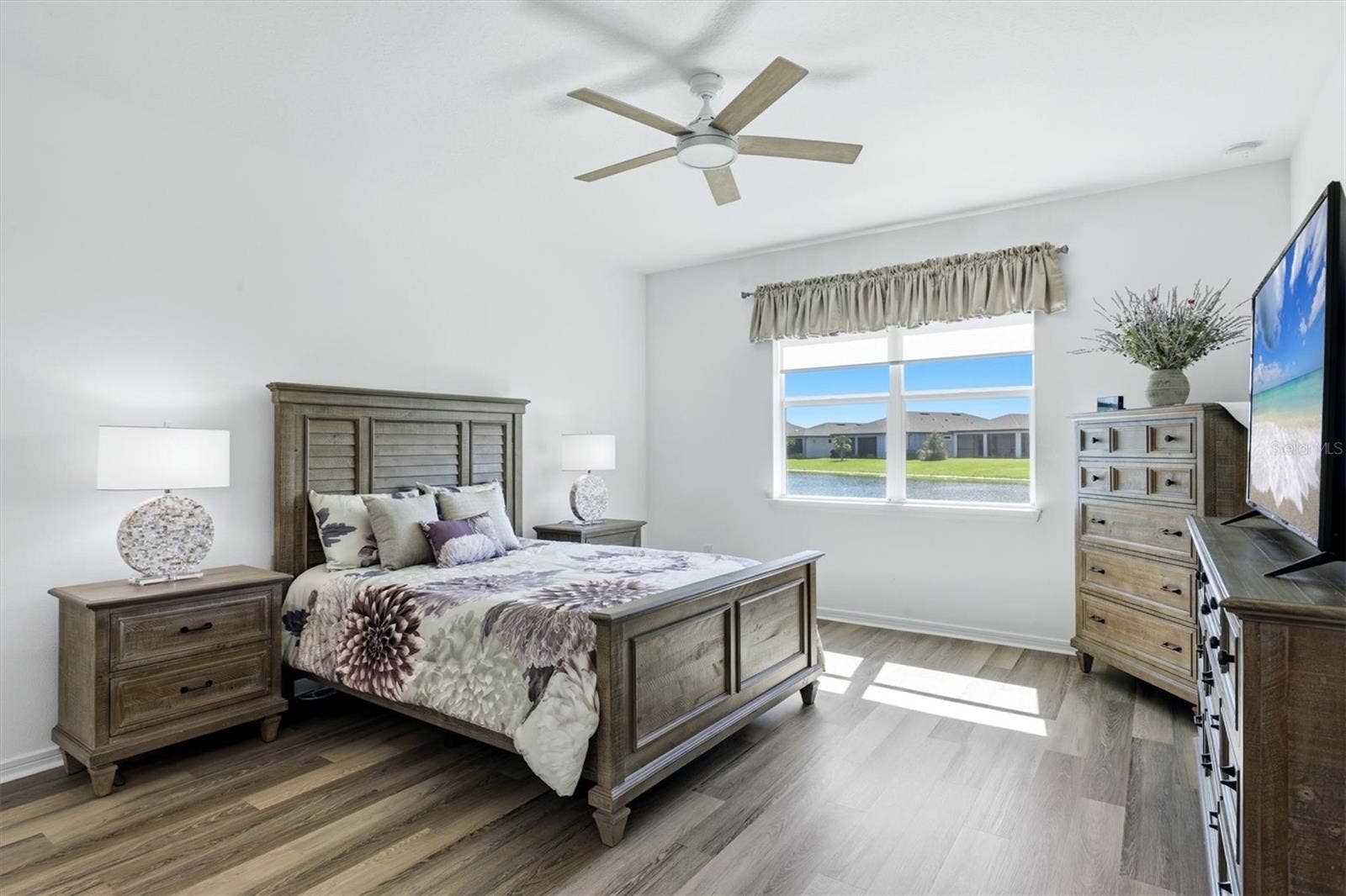 10635 WYNWARD WAY, Parrish, FL 34219 Primary Suite with pond view. Very spacious with newer LPV flooring.