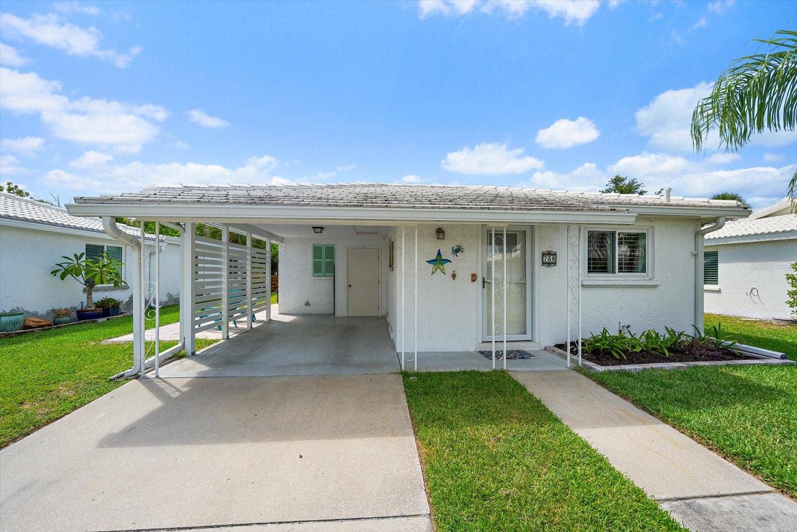 Exterior front view of unit and carport