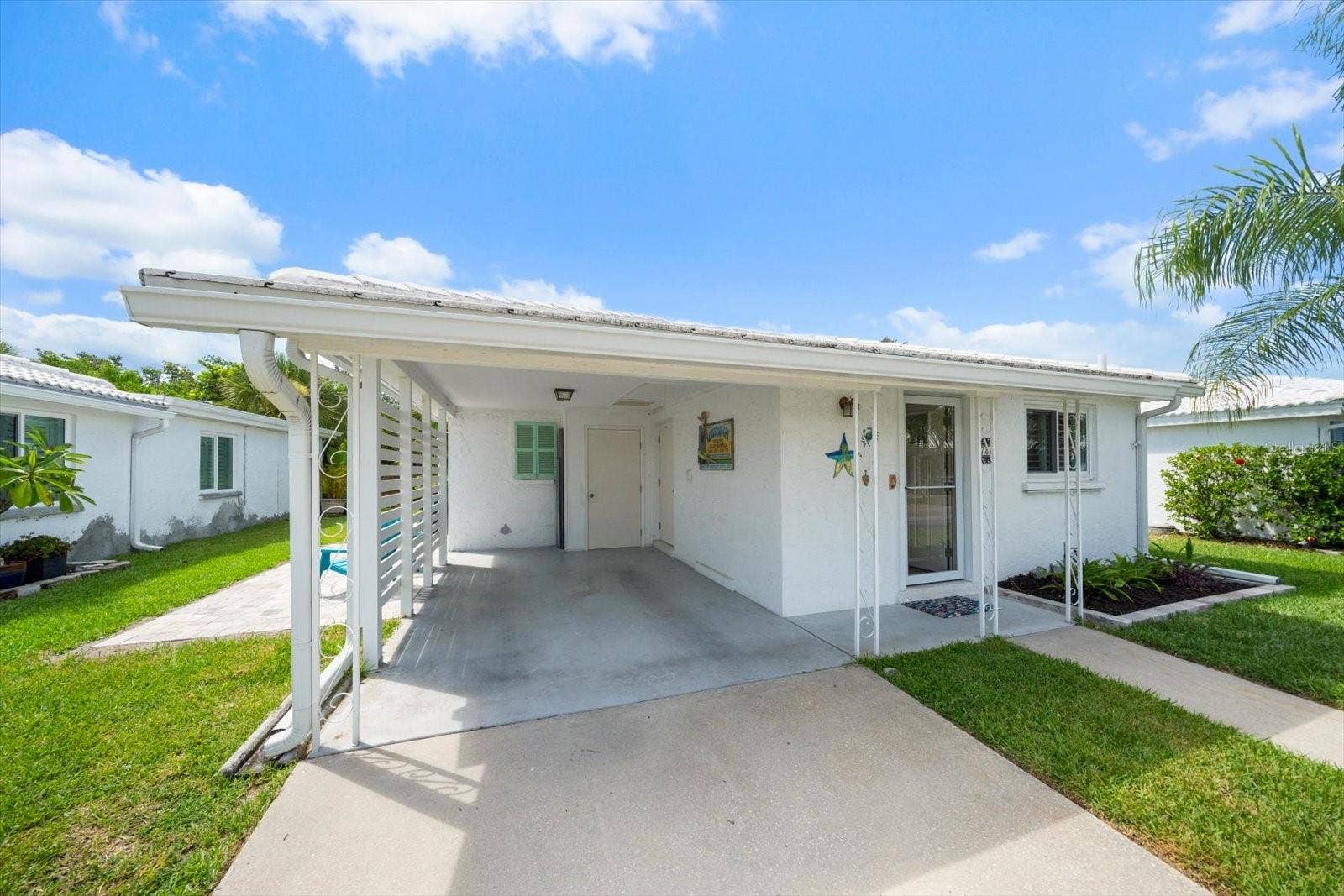 Exterior front view of unit and carport