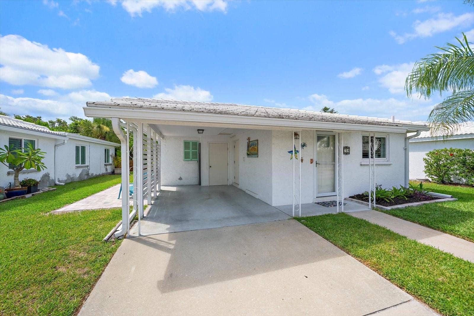 Exterior front view of unit and carport