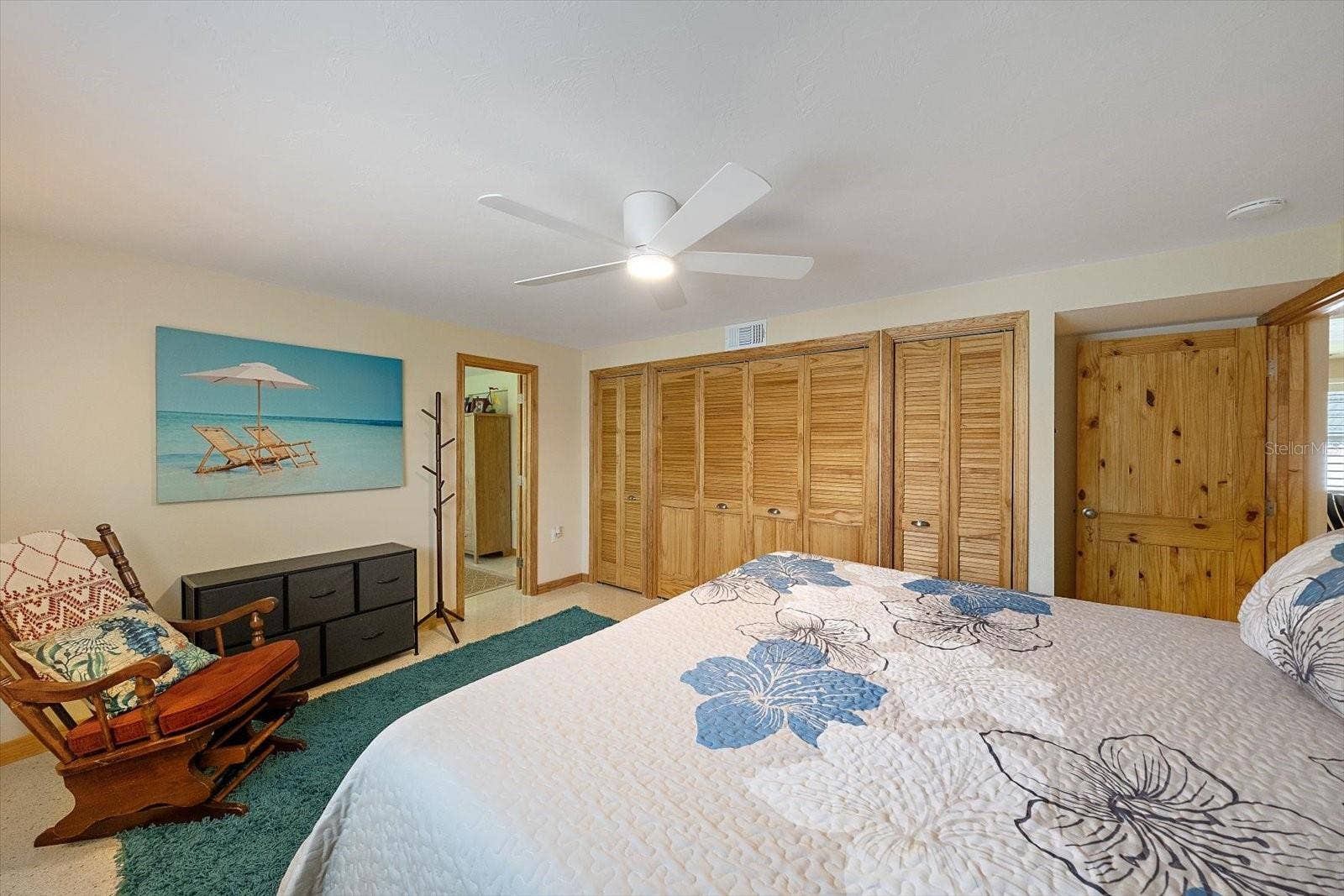 Bedroom with ceiling fan and nautical decor