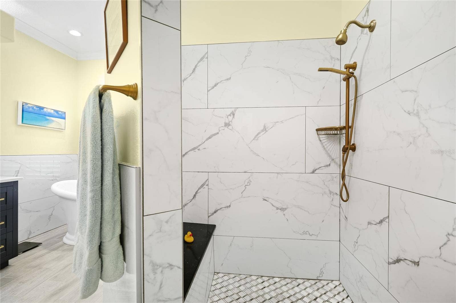3306 LITTLE COUNTRY ROAD, Parrish, FL 34219 Primary bathroom walk-in shower with custom tile, updated plumbing fixtures, and built-in bench.